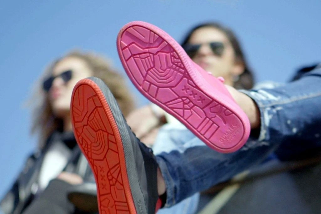 Original GUMSHOE photograph with pink and red map-patterned outsoles facing the camera